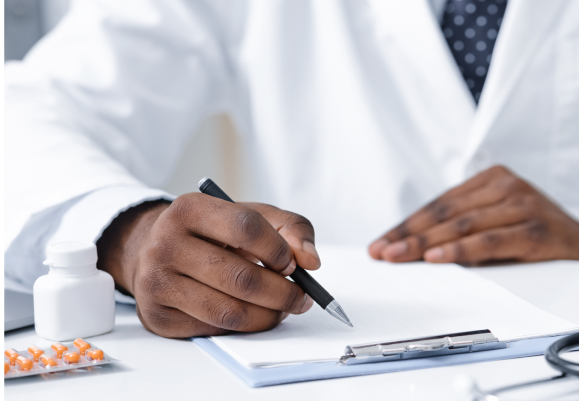 Doctor writing on a notepad